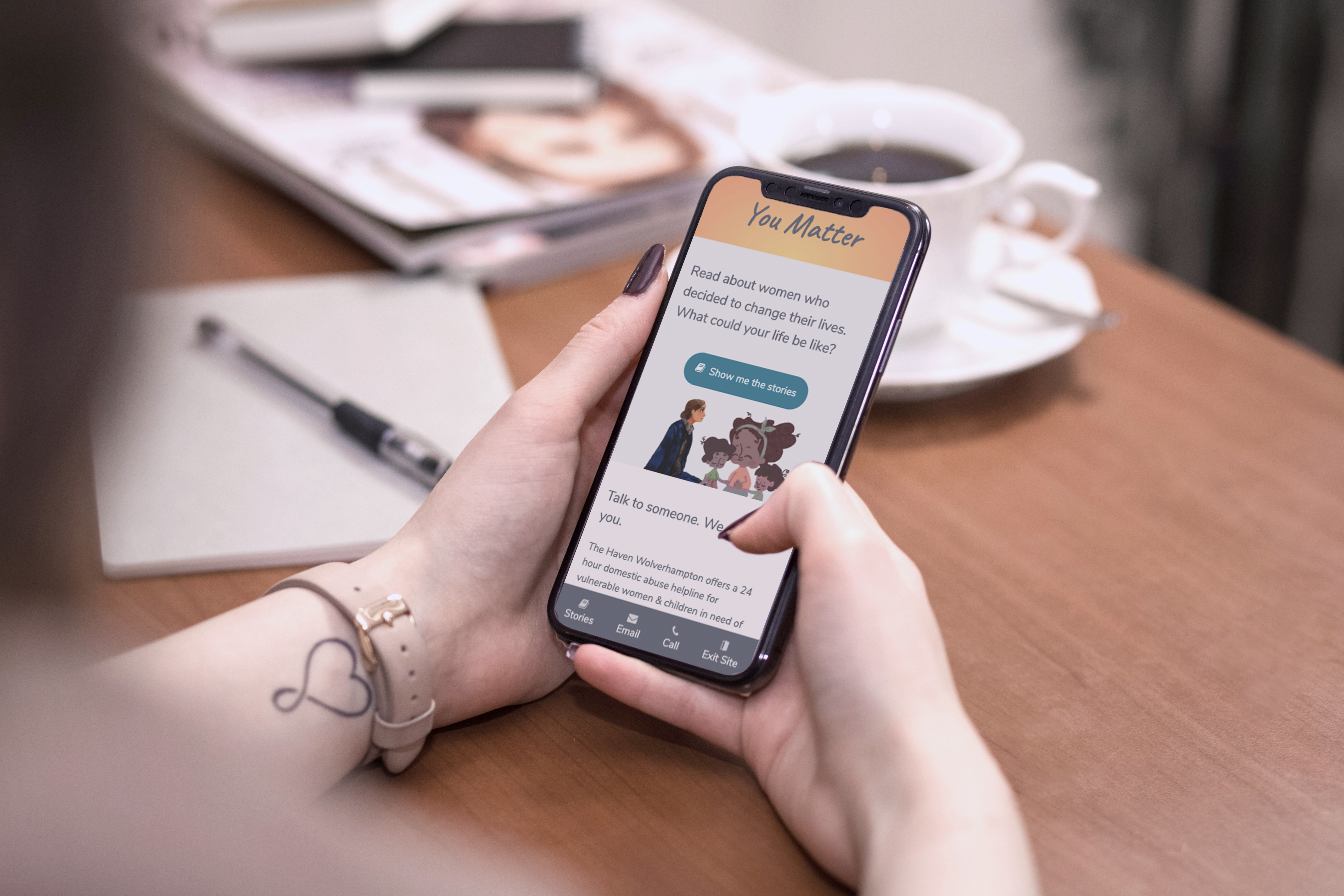 Hands holding a phone showing The Haven 'You Matter' app.